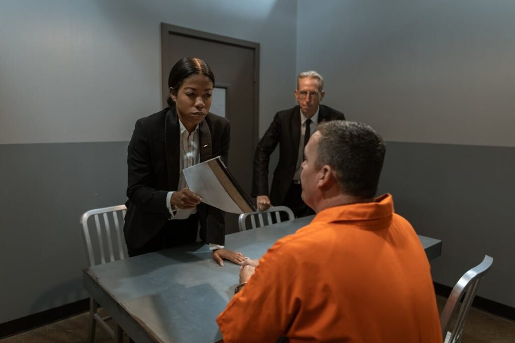 Man in Black Suit Jacket Standing Beside Man in Orange Dress Shirt